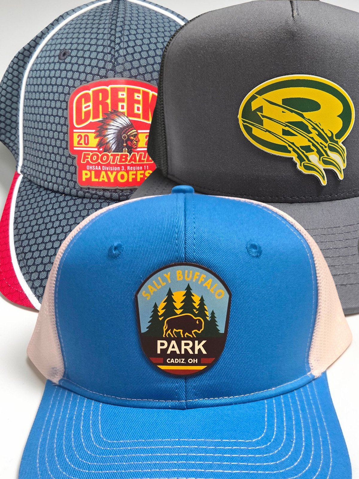 Closeup of custom patch hats with leatherette and printed patch styles